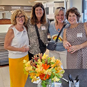 Carolyn Manhatton of Excelsior Paint and Design in Excelsior, Minnesota, standing with other women at the meet and greet.